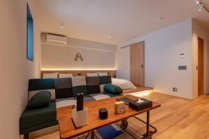 a living room with a couch and a table at Hotel Arina HakataTaihaku in Fukuoka