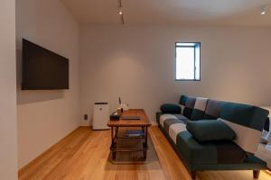 a living room with a couch and a table at Hotel Arina HakataTaihaku in Fukuoka +26 photos