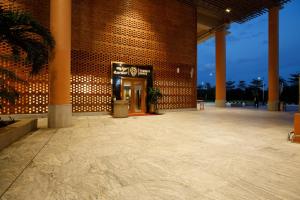 a brick building with a lobby with a palm tree at 080 Transit Hotel, T2 in Bangalore