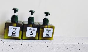 three bottles of mustard sitting on a counter at Staypineapple in Quy Nhon