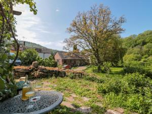 a view of a garden with a table and chairs at Ferryman's Lodge in Chepstow