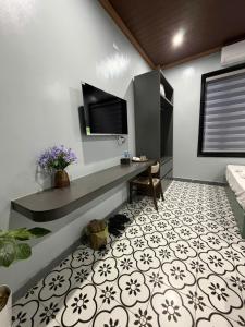 a room with a desk and a tv on the wall at Bông Phố Cổ Homestay in Ninh Binh +7 photos