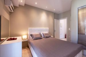 a bedroom with a large bed in a room at Beach Villa Christina by PosarelliVillas in Acharavi +23 photos