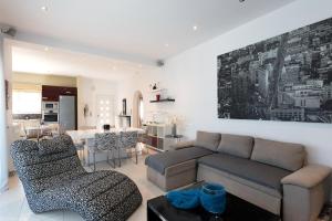 a living room with a couch and a table at Beach Villa Christina by PosarelliVillas in Acharavi