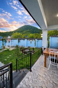 a balcony with a table and chairs and a view at Gabala Luxury Nature Villa in Gabala
