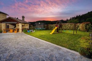 a backyard with a playground with a slide at Villa Palazza in Pazin