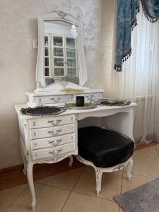 a white dressing table with a mirror and a stool at LuxHouseNiksic in Nikšić