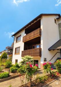 a building with balconies and flowers in front of it at Unterkunft-Uettingen in Uettingen