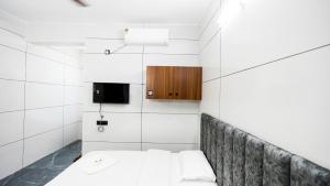 a small bedroom with a bed and a cabinet at Sreebhadra Residency in Chavara