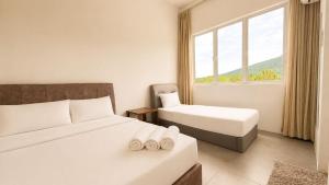 a hotel room with two beds and a window at Casa Le Dream (03) in Kuah +28 photos