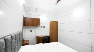 a small room with a bed and a desk at Sreebhadra Residency in Chavara