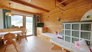 a log cabin with a dining room and a bedroom at Sonnseit in Sankt Johann in Tirol