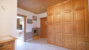 a kitchen with wooden cabinets and a kitchen with a stove at Sonnseit in Sankt Johann in Tirol