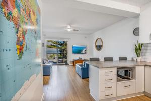a kitchen with a large world map on the wall at Beachfront self contained upstairs apartment in Semaphore