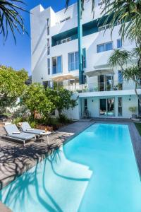 a swimming pool in front of a building at Zest Boutique Hotel by The Living Journey Collection in Cape Town