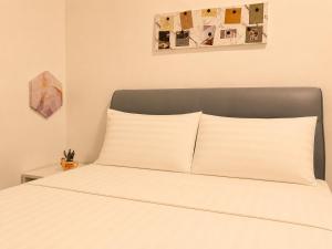 a bed with white pillows in a bedroom at Casa Le Bliss (13) in Kuah
