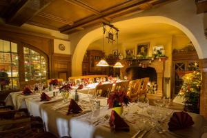 a dining room with a long table with wine glasses at Lahntalhotel Feudingen in Bad Laasphe +39 photos
