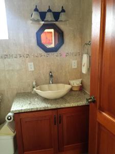 a bathroom with a sink and a toilet at Casa de la Tortuga in Zihuatanejo