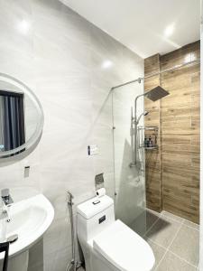 a bathroom with a toilet and a sink and a shower at Ngôi Nhà Mơ Ước in Ho Chi Minh City +30 photos