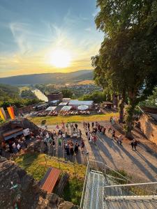 a crowd of people standing on a street with the sunset at Main Panorama Suite 97896 Freudenberg in Freudenberg am Main
