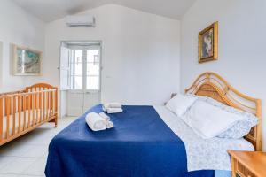 a bedroom with a blue bed with two towels on it at Casa in Via Seminario Otranto in Otranto