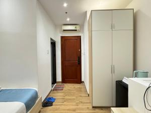 a small bedroom with a bed and a closet at Ngôi Nhà Mơ Ước in Ho Chi Minh City