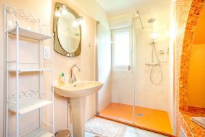 a bathroom with a sink and a shower at Chez Coco in Trégunc +31 photos