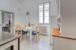 a kitchen and dining room with a table and chairs at Casa in Via Seminario Otranto in Otranto