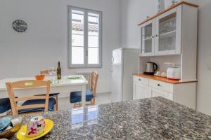 a kitchen with a table and a counter top at Casa in Via Seminario Otranto in Otranto +28 photos