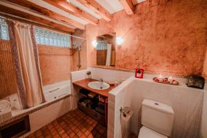 a bathroom with a white toilet and a sink at Casona del Tambor in Calatañazor +18 photos