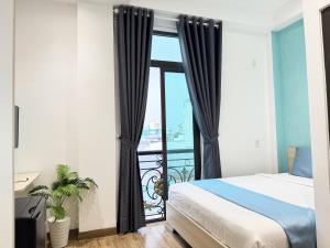 a bedroom with a bed and a balcony at Ngôi Nhà Mơ Ước in Ho Chi Minh City
