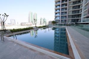 a swimming pool in the middle of a building at Modern Waterfront Studio | Steps from Cleveland Clinic in Abu Dhabi