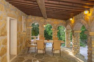 an outdoor dining room with a table and chairs at Le Querciolaie with Geothermal Pool - by PosarelliVillas in Monteverdi Marittimo