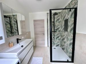 a bathroom with a shower and a sink at Ferienwohnung Petritz in Velden am Wörthersee +82 photos
