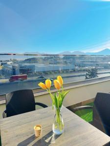 a vase with yellow flowers sitting on a table at Aurelis Hotel in Bërxull