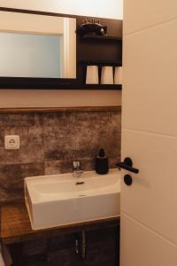 a bathroom with a white sink and a mirror at Fun & Relax Park Thurnau in Thurnau +50 photos