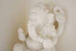 a white statue of an elephant standing next to a wall at Tropical Villas Complex in Jimbaran