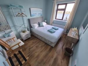 a small bedroom with a bed and a table at Cuchulainn Townhouse in Galway