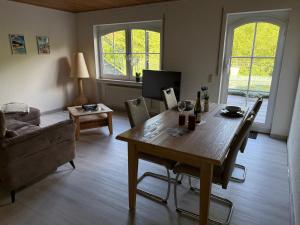 a living room with a wooden table and a couch at Moseloase am Weinberg mit Pool und Sauna in Bullay in Alf