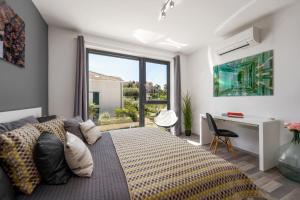 a bedroom with a bed and a desk and a window at Casa Seal by Briskva in Funtana +37 photos