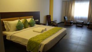 a bedroom with a large bed in a room at The King's Hotel in Tuticorin
