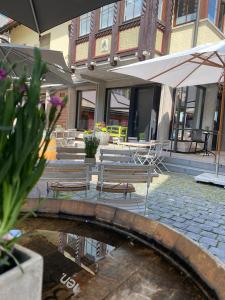 a bridge with two benches and a table and an umbrella at Hotel Bären in Schramberg