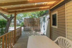 a wooden deck with a wooden pergola at Mobil-home - Le 147 aux Iscles in La Roque-dʼAnthéron