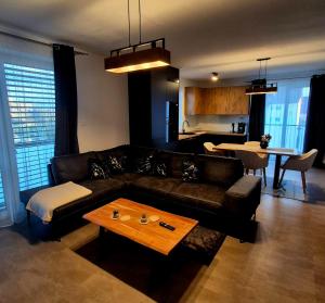 a living room with a couch and a table at Apartments Javor in Veľký Slavkov
