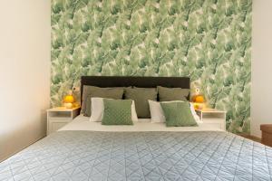 a bedroom with a bed with a green and white wall at Hotel Costa Blanca Rojales in Rojales +140 photos