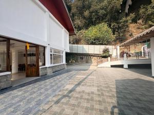 ein leerer Innenhof eines weißen Gebäudes mit einer Tür in der Unterkunft Hotel B Wings in Tādong