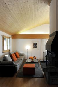 a living room with a couch and a table at Chalet Bühlweidli by Ferienlenk in Lenk