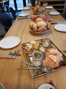 a wooden table with a tray of food on it at Hotel Bären in Schramberg +6 photos
