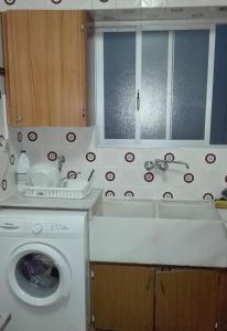 a kitchen with a washing machine and a window at Apartamento Rural La Plaza Vieja in Viver +39 photos