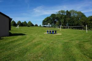 a large field with a volley ball net at Camping 3 étoiles - Piscine - ccbgaci in Illiers